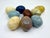 Vintage alabaster hand caved Easter eggs made in Italy. A variety of colors and sizes in browns, yellows and blues.