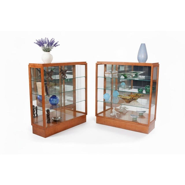 This exceptional pair of glass vitrines is a luxurious example of furniture design from the Art Deco period, manufactured...