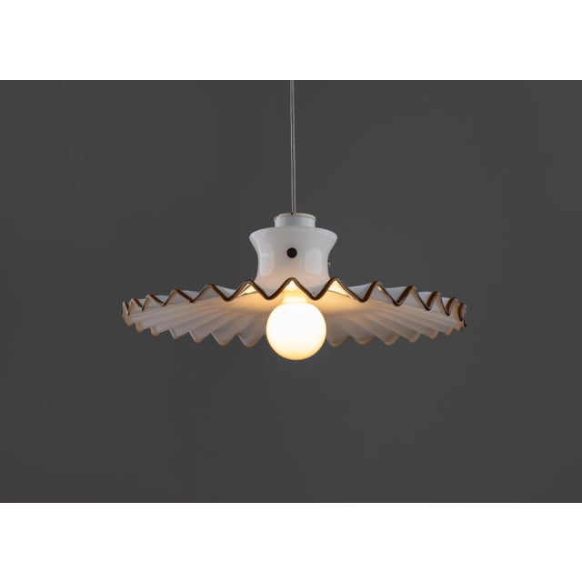 Pinocchio pendant lamp by venini from the 1980s. Original authorship signature present. The refined silhouette, wavy edge,...