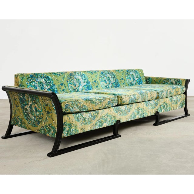Fantastic mid-century modern upholstered gondola sofa made in the style and manner of James Mont. The chic sofa features a...