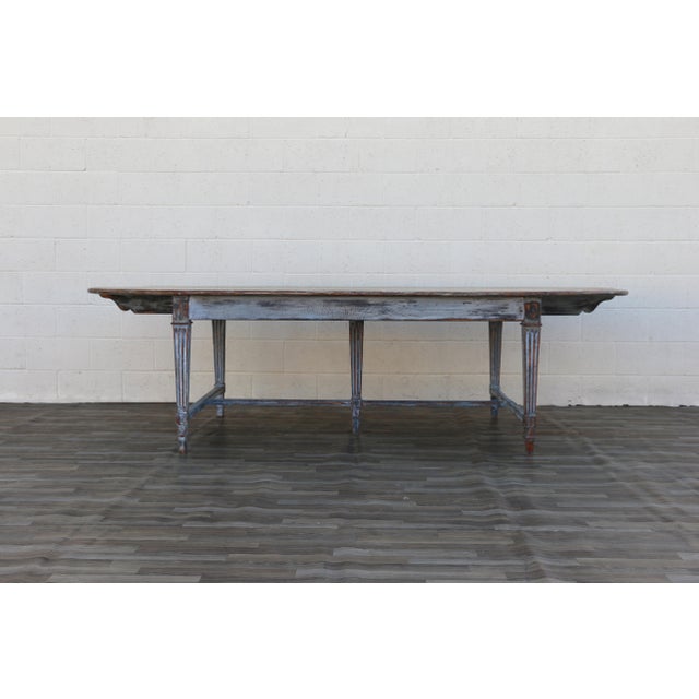 Beautiful antique French Provincial dining table dating to circa 1920s, featuring an impressive large oval form and...
