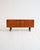 Scandinavian teak sideboard with sliding doors, four central drawers, and integrated carved handles. "Comet" model,...