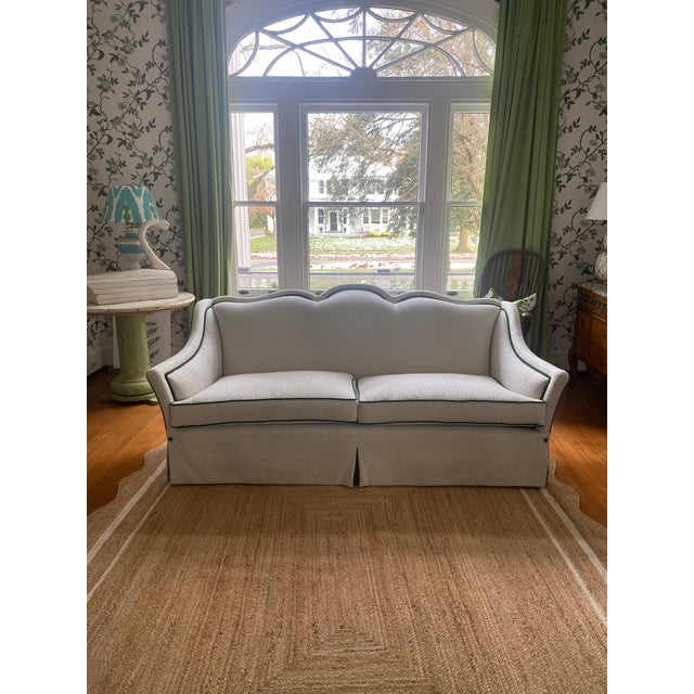 Stylish sofa with unusual scalloped back. .So very lady like. Green velvet ttrim adds detail to the oyster upholstery ....