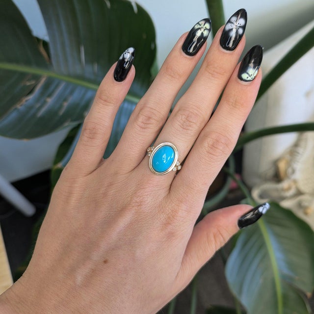 A vivid turquoise cabochon from Arizona anchors this bold ring, accented with earth-mined diamonds in solid 14K yellow...