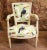 Trendy pair of Regency style painted arm chairs. Feature a very distinctive and colourful fabric showing various Tucans...