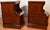 A matching pair of antique style wooden nightstands crafted in a rich, warm wood finish. Each piece features a rectangular...