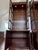 An exceptional matched pair of Henredon lighted display cabinets, exquisitely crafted in richly figured mahogany and...
