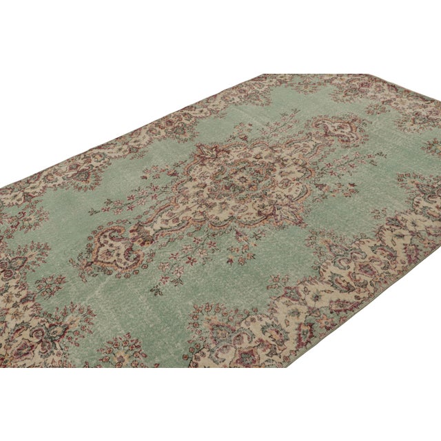 Hand Knotted in wool, this 6x9 vintage Turkish rug originating from Turkey, circa 1960-1970, features a unique addition to...