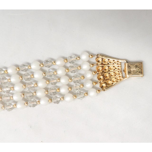 This is part of Chairish’s Costume Jewelry assortment. 1950s goldtone 5-strand round faux-moonstone beads and faceted...