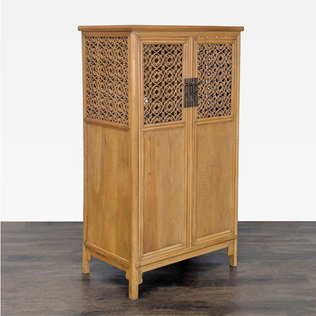 Illuminated cabinet with interior shelving, hand carved top door panels, and locking pin. Original Price: $700. Dimensions...