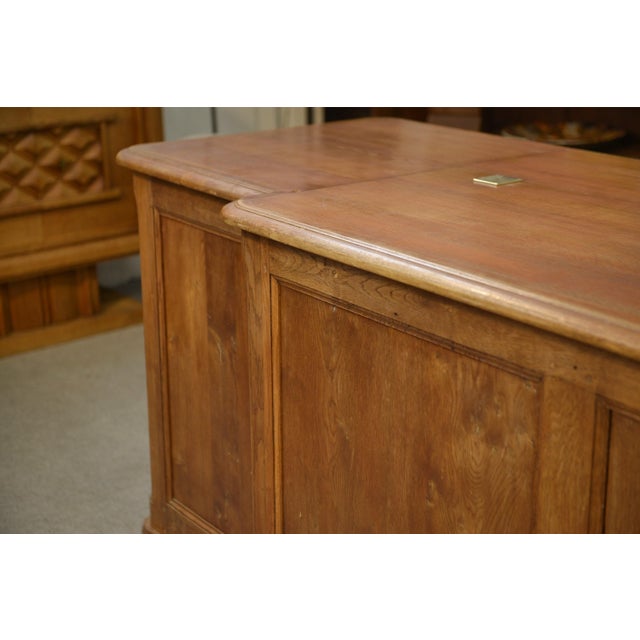 A superb antique oak counter, typical of early 20th-century shop and workshop design. Its large-paneled front, punctuated...