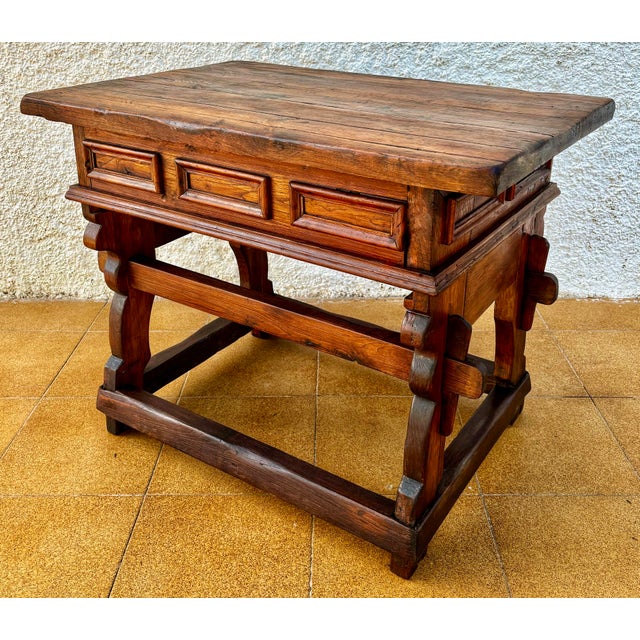 Solid Spanish work table crafted from hardwood during the early-20th century, featuring a robust rustic design and...