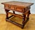 Solid Spanish work table crafted from hardwood during the early-20th century, featuring a robust rustic design and...