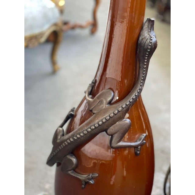 Pair of lizard iron-mounted glazed earthenware vases. Made in Italy, 20th Century. Dimensions: 42"H x 12"D