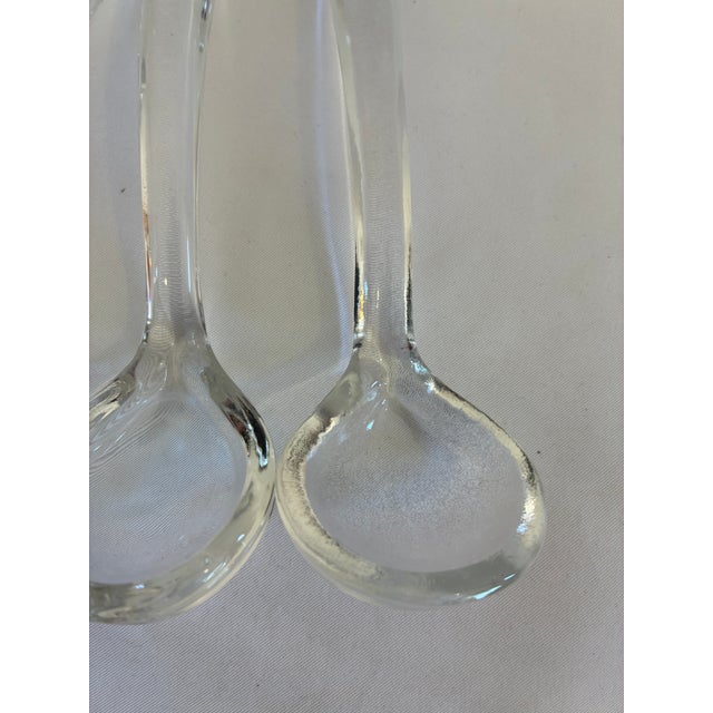 A lovely set of three vintage clear glass ladles featuring rounded bowls and tapered handles. These elegant yet...