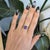A 2.74-carat cushion tanzanite glows in a velvety blue at the heart of this solid 14K yellow gold ring, framed by ten lab...