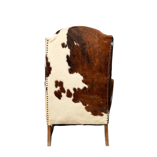 This distinctive armchair features a leather seat and ponyskin-covered backrest, creating a strong visual impact and...