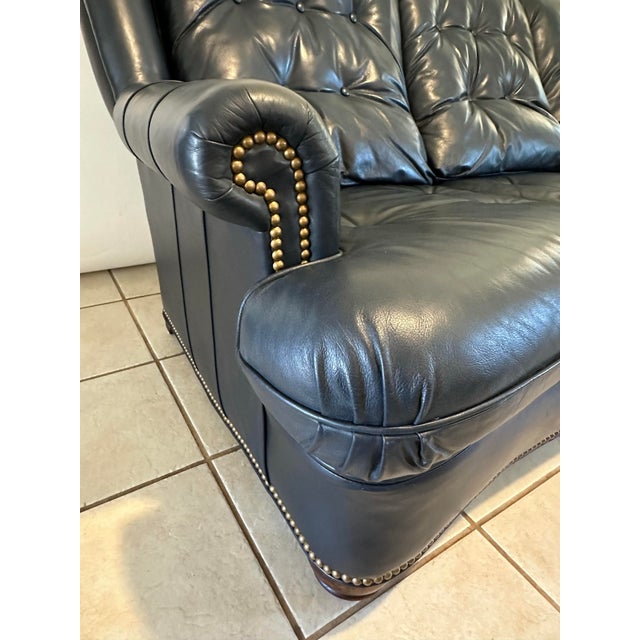 Elevate your interior with this exquisite vintage Regency-style leather sofa, masterfully crafted in rich navy blue slate...