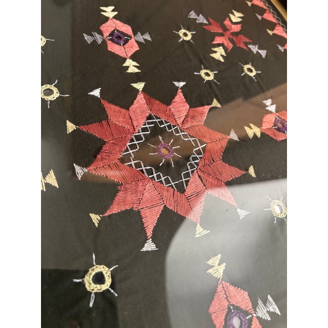 Pink and cream silk embroidery on black linen with small mirrored pieces embroidered in. Star quilt patterns and sawtooth...