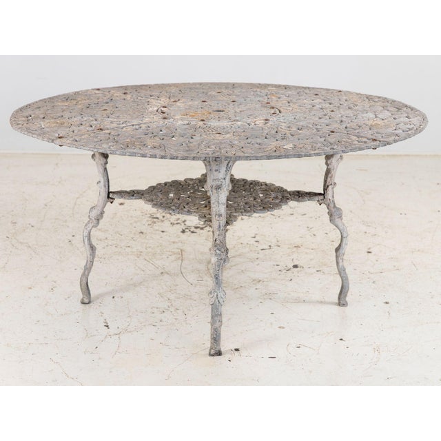This 1960s Swedish cast aluminum garden dining table features a beautifully detailed round top adorned with a repeating...