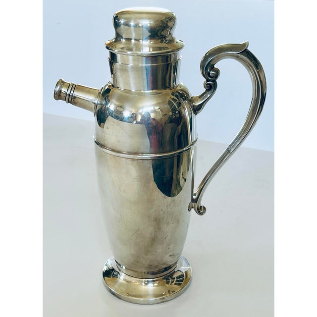 MCM cocktail shaker in silver plate. Spout stopper is screw on and the top stopper is a push on. ART S.CO. stands for Art...