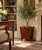 A handsome mid-20th-century mahogany planter or wastebasket, distinguished by its tapered form, turned corner supports,...