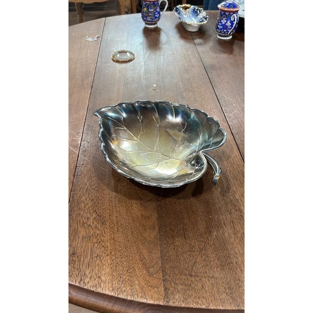 Add classic botanical charm to your space with this vintage silver-plated leaf dish. Designed with sculpted vein details...