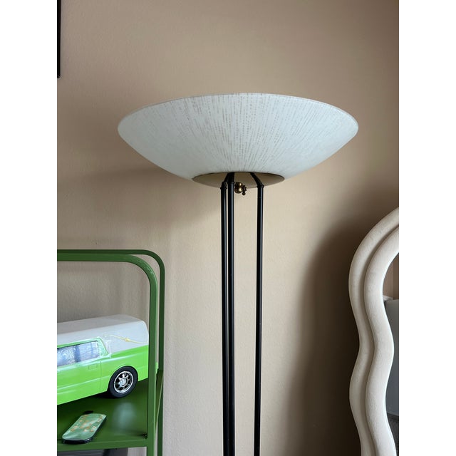 Upgrade your space with this iconic pair of vintage torchiere floor lamps designed by Gerald Thurston for Lightolier....