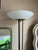 Upgrade your space with this iconic pair of vintage torchiere floor lamps designed by Gerald Thurston for Lightolier....