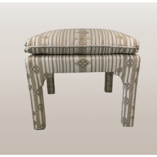 A subtle yet striking custom pair, these ottomans are newly upholstered with Larson's 'Kenya' fabric in color 'Shell.'...