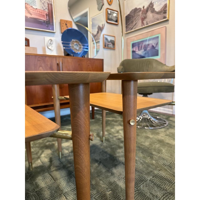 A pair of mid century modern side tables in the style of Paul McCobb, circa 1960s. These tables embody the timeless...