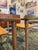 A pair of mid century modern side tables in the style of Paul McCobb, circa 1960s. These tables embody the timeless...
