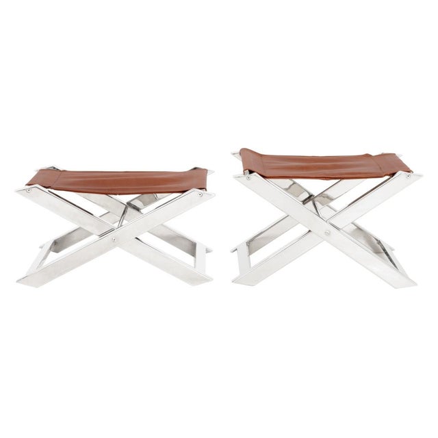 Pair of Charles Hollis Jones Style Chrome Folding Stools, with cognac leather covered seats. 14" H x 24" W x 13" D....