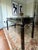 Statement piece desk. Lacquered black finish with brass accents. Two drawers. Minor wear due to age. Otherwise, in great...