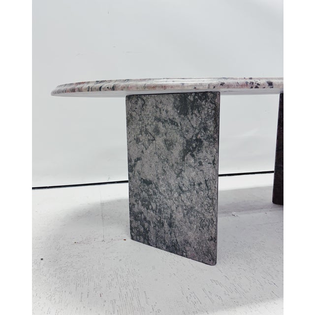 Oval vintage coffee table crafted from solid marble, featuring a unique mix of red, green, grey, and cream tones. The...