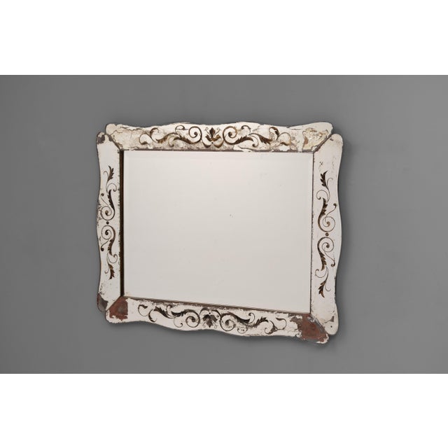 Venetian style mirror with shaped and decorative edge panels. Circa 1930.