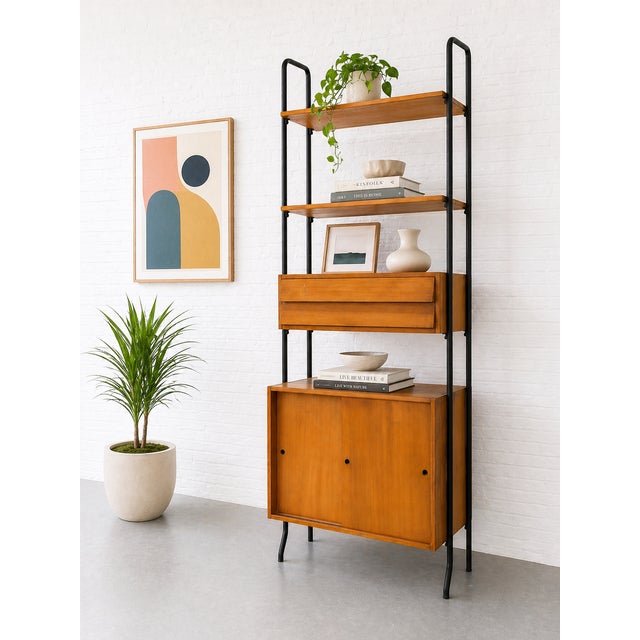 Vintage Mid Century Modern Italian wall unit featuring warm teak and a sleek black metal frame. This architectural piece...