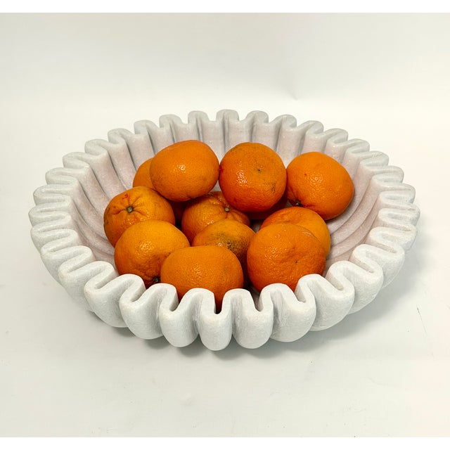 Handcrafted ruffled/fluted marble bowl is perfect for displaying fruit or small objets. A stunning catch-all for as much...