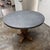 Design Plus Gallery presents the Salvaged Wood & Weathered Concrete Trestle Round Dining Table designed by Timothy Oulton...