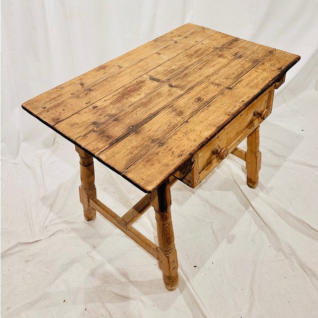 Antique Spanish Colonial table made from bleached wood featuring a single frieze drawer with two knobs, a rectangular top,...