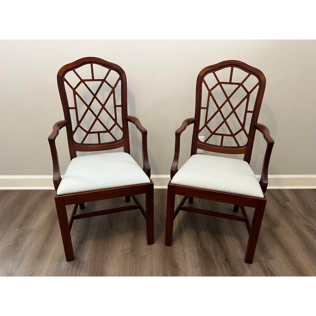Pair of Late 20th Century Chinese Chippendale Chinoiserie style dining arm or captain’s chairs with fretwork back and...