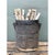 This vintage wood bucket is a striking example of hand-hewn utilitarian craft, carved from a single tapering cylindrical...