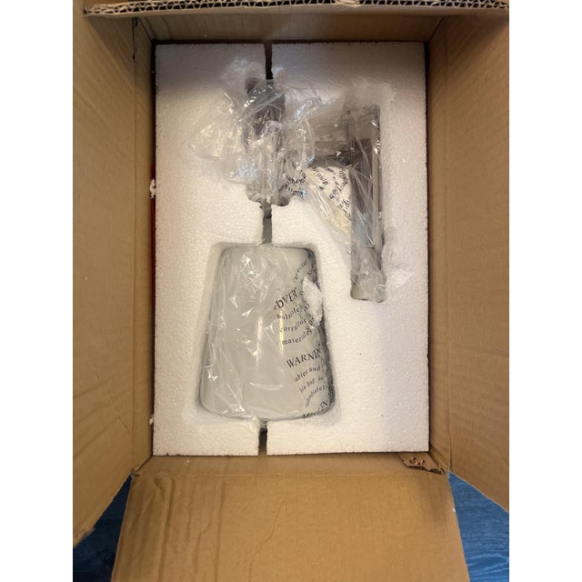 This piece is a never-been-used, discontinued sconce from Visual Comfort. It features a classic silver silhouette with a...