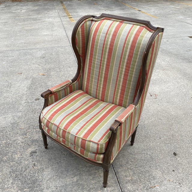 Wooden classic accent chair in good vintage condition. Striped upholstery is in good condition. Can use new upholstery....