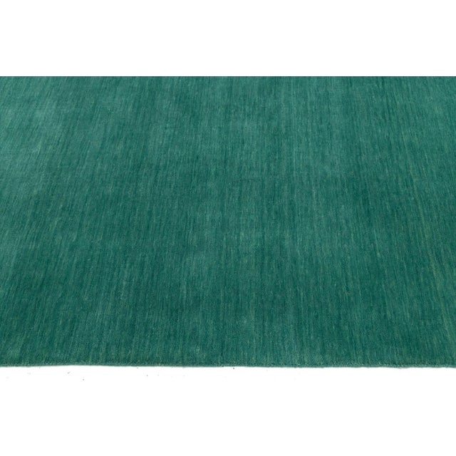 Discover our stunning handcrafted Gabbeh-style wool rug, showcasing a rich Jewel-Toned Green design. Proudly part of our...