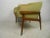 Mid-Century Modern walnut frame lounge chair with barrel back rest and tufted green upholstery. A wide design with...