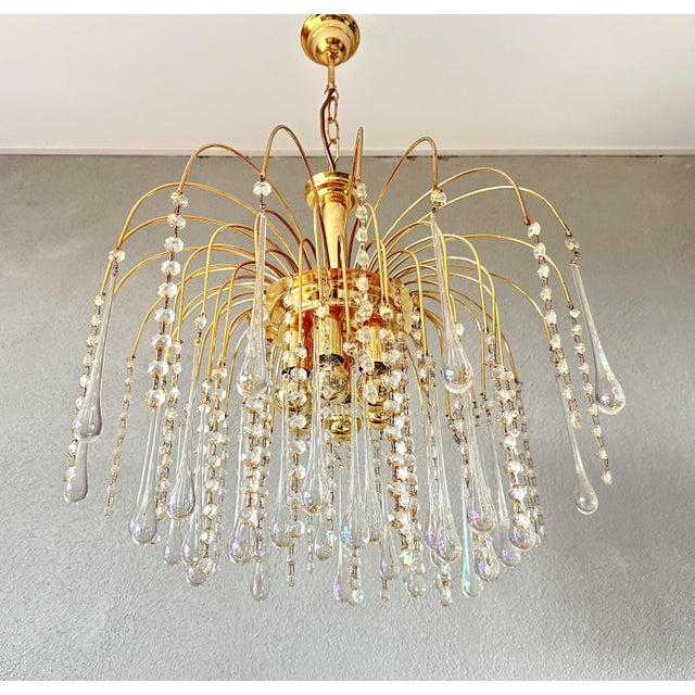 Beautiful, luxurious Italian chandelier. This large 1970s lamp, with its iridescent glass teardrops, is truly a feast for...