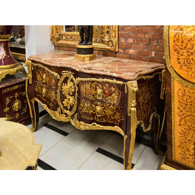 A true masterpiece of French-inspired luxury, this stunning Louis XV Bombe Commode showcases an elegant serpentine...