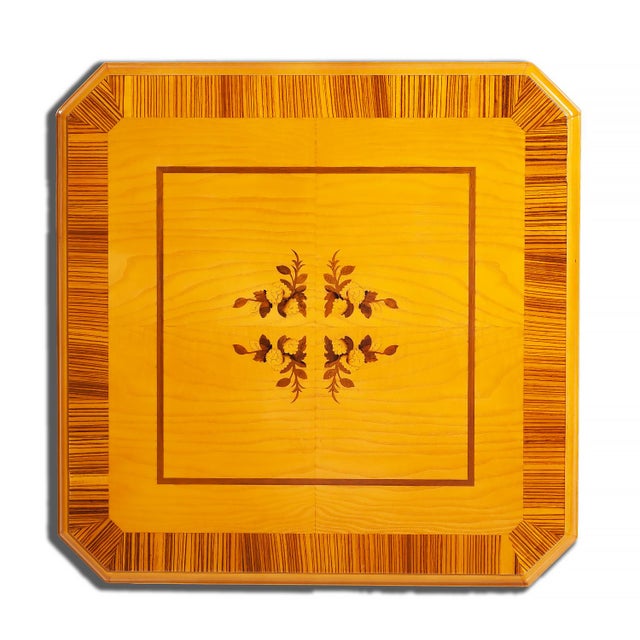 Handcrafted in Italy with a richly detailed Myrtle Burl veneered top, this elegant table features intricate floral inlays...