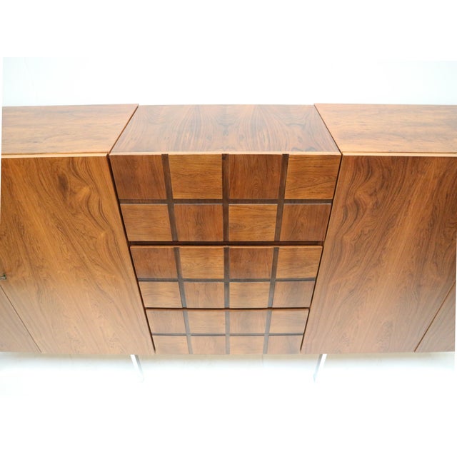Unique vintage design sideboard made of rosewood with a bar section from the 1960s. This beautiful vintage sideboard from...